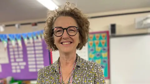 Holy Trinity CofE Academy A woman in a green and white blouse 