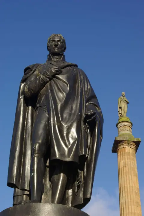 Stephen McKay/Geograph A large statue of a man standing, with another taller statue visible behind it.