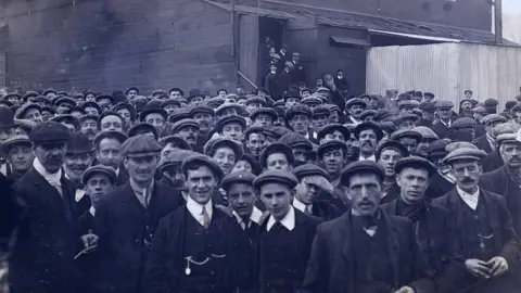 Getty Images | Universal History Archive Massive crowd of striking miners, the majority in flat caps, shirt collars and jackets
