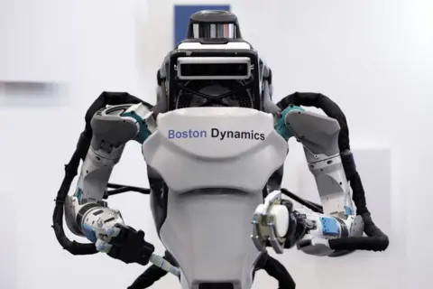 The Atlas robot standing with its arms bent
