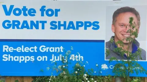 Brian Farmer/BBC A Shapps election poster on a fence