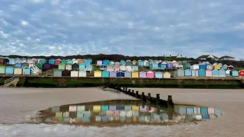 SINBAD/BBC Weather Watchers Rows of colourful beach huts lined up at the beach in Walton-on-the-Naze in Essex.