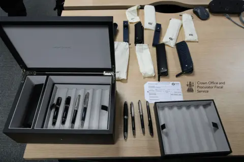 COPFS Crown Office photograph of pens on a wooden desk