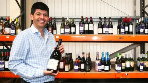 Auctioneer Paul Cooper, of Eddisons, with wine from the Pride and Provenance restaurant