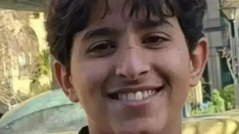 South Yorkshire Police A teenage boy with dark hair smiles into the camera.