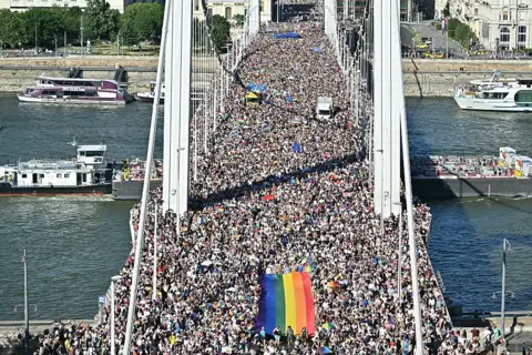 Getty Images Vast crowd of people on Budapest's Elisabeth Bridge, including big rainbow flag