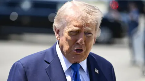 US President Donald Trump speaks to reporters before boarding Air Force One in Palm Beach, Florida.
