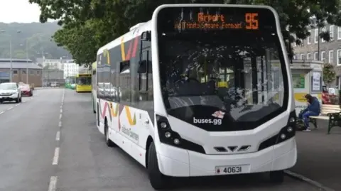 A white bus with information on the screen showing the route number of 95 and  "Airport".