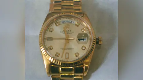 Thames Valley Police A picture of a gold Rolex watch against a plain background.