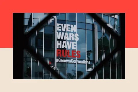 A sign saying 'Even Wars Have Rules' on a glass rotunda