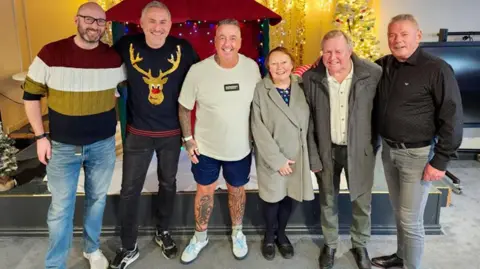David Airey Six of the the volunteers at Chorley FC last year standing in front of a Christmas display