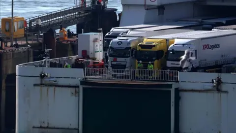 Lorries wait to disembark a ferry at the Port of Dover in England