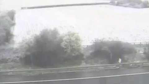 National Highways Snow settled on a field by the M5 in Gloucestershire