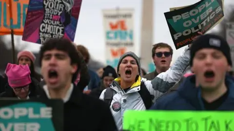 Getty Images Protesters shout during the People's March