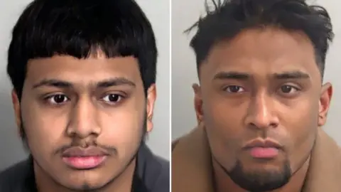 Essex Police Mugshot of Aaryan Noor Ali (left) and Junead Ahmed. Noor Ali is looking away from the camera. He has a dark moustache, sideburns and a bowl cut on top. Ahmed has a groomed, dark chin beard and dark short hair, which is slightly ruffled and longer on top