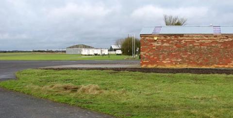 Airfield showing taxiway and brick wall