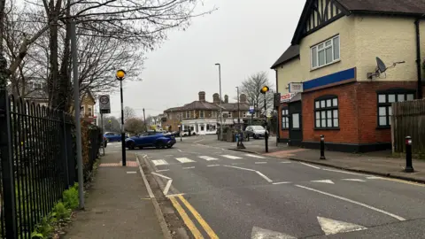 Zebra crossing and on the right there is a Tesco metro