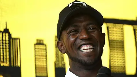 Biniam Girmay smiles during a press conference