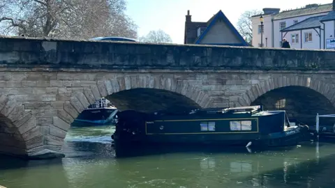 A boat resting on Folly Bridge on the River Thames in Oxford.