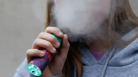 EPA A child uses a vaping product in London, Britain, 26 March 2024. 