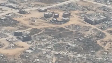 An aerial image of a dusty and destroyed Gaza