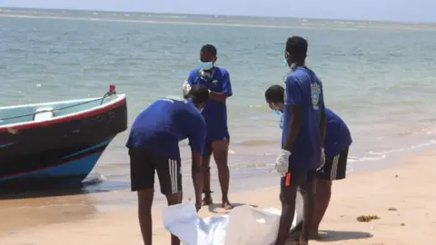 Djibouti Coast Guard Rescuers carry recovered bodies in body bags