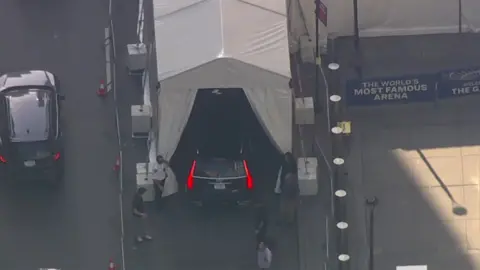 A black SUV drives into a tent in Madison Square Garden