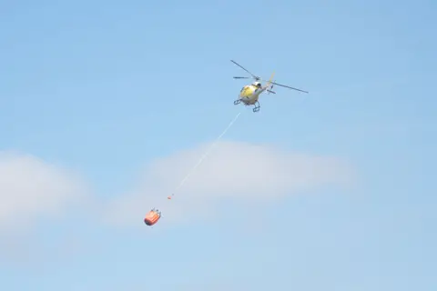 Helicopter deploying water