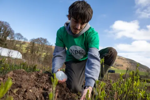 NPK Recovery NPK Recovery junior R&D scientist George Barnsley testing the soil at Stump up for Trees nursery near Abergavenny