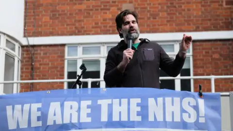 Getty Images Rob Delaney with a We Are The NHS! banner