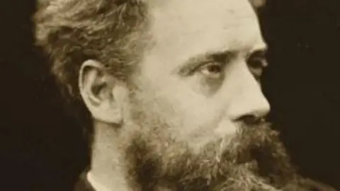 St Mary de Crypt An old black and white picture of WE Henley. He has a long beard and is not looking at the camera