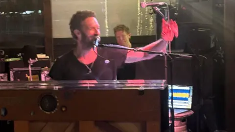 Jodie Smith Chris Martin playing the piano and smiling at the  Puzzle Hall Inn in Calderdale