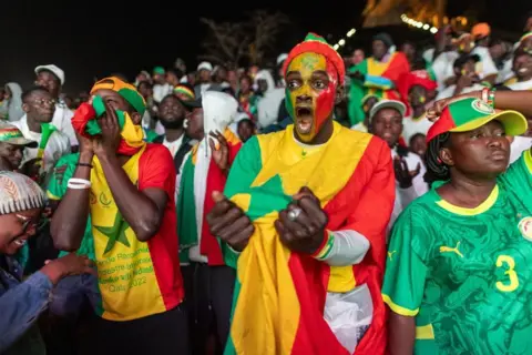 EPA Senegalese soccer fans cheer as they watch the Africa Cup of Nations (AFCON) final match between Senegal and Morocco in Dakar