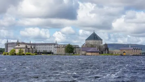 Getty A number of buildings can be seen at St. Patrick's Purgatory, commonly referred to as Lough Derg.
A number of buildings and bushes and trees are pictured on Lough Derg, a lake in County Donegal.