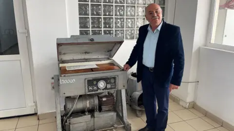 Petre Filip with his original packaging machine