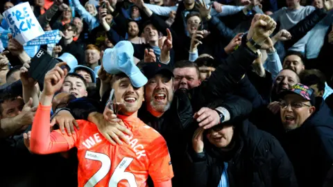 PA/ Richard Sellers Coventry-born player Josh Eccles celebrates with fans, after Coventry City's point at Blackburn Rovers guaranteed their return to the Premier League after 25 years.