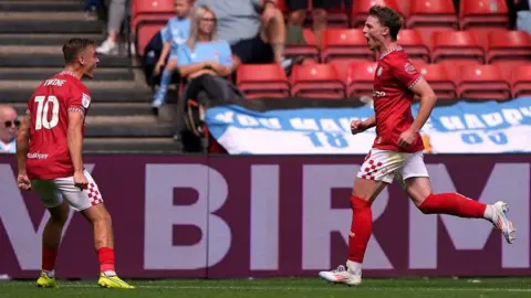 PA Media Two Bristol City players run towards each other in celebration after taking the lead against Coventry City at Ashton Gate