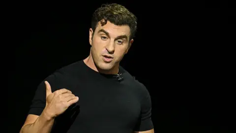 Airbnb co-founder and chief executive Brian Chesky, wearing a black t-shirt, speaking about the launch of Airbnb Services during his keynote at an event in Los Angeles, California, on 13 May, 2025.