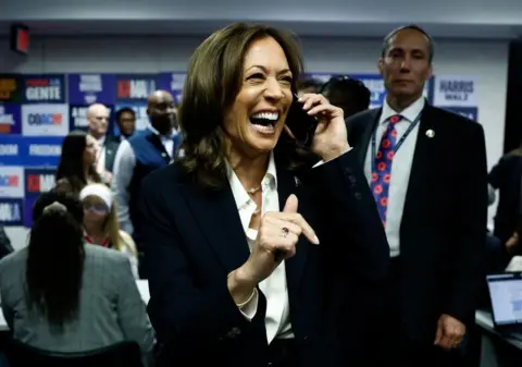 Evelyn Hockstein/Reuters Democratic presidential nominee U.S. Vice President Kamala Harris reacts as she talks on the phone at the Democratic National Committee (DNC) headquarters during the 2024 U.S. presidential election on Election Day in Washington, U.S., November 5, 2024.