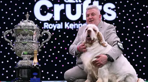 Owner Lee Cox and his clumber spaniel next to the Crufts trophy