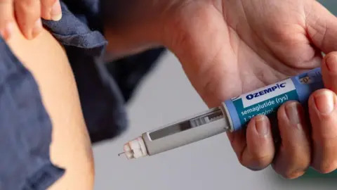 A person injects weight-loss drug Ozempic