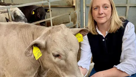 Country Land and Business Association A woman with a cow.
