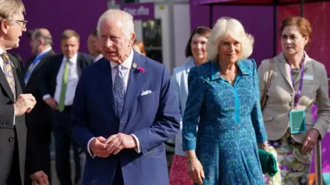 Reuters King Charles and Queen Camilla walk in the sunshine at the Chelsea Flower Show