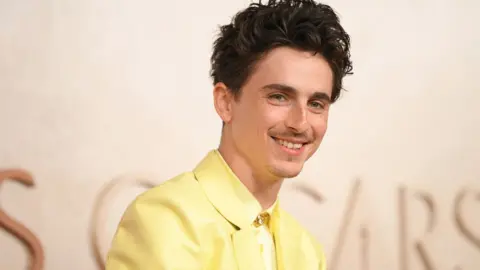 Timothée Chalamet pictured last month wearing a yellow suit