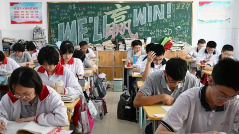 HAO QY / Feature China/Future Publishing via Getty Images Examinees prepare for the national college entrance exam, better known as the Gaokao, in the last morning reading session in Handan city in north China's Hebei province