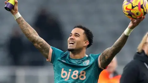 Reuters AFC Bournemouth's Justin Kluivert celebrates with the match ball and the player of the match