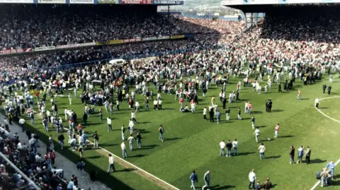 Hillsborough Inquests/PA Fans on the pitch in the aftermath of the Hillsborough disaster.