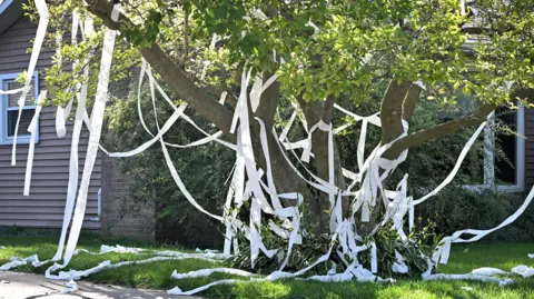 A house is littered with toilet paper