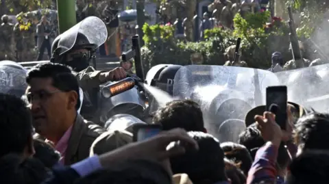 AFP A soldier sprays people with tear gas