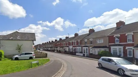 Google A Google street view image of Ferndale Road in Swindon. It has terraced houses either side and a silver car is visible driving down the road in the foreground